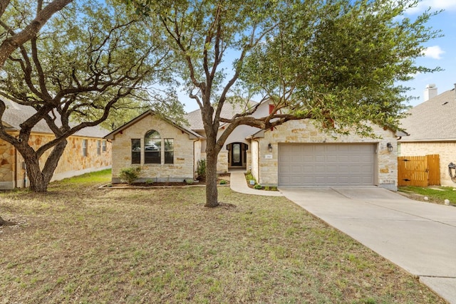 250 Maeves Way, Austin, TX 78737 - view of front of house with concrete driveway, stone siding, and a garage