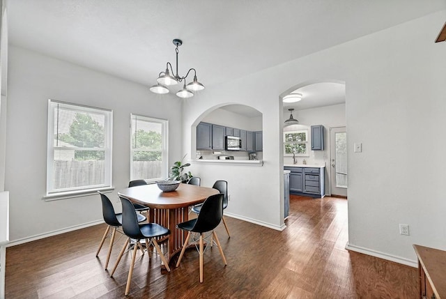 808 N Creek Blvd, Leander, TX 78641 - dining room featuring dark wood-style flooring, baseboards, and arched walkways