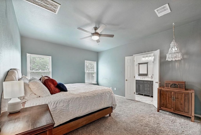808 N Creek Blvd, Leander, TX 78641 - bedroom with multiple windows, carpet, connected bathroom, and baseboards