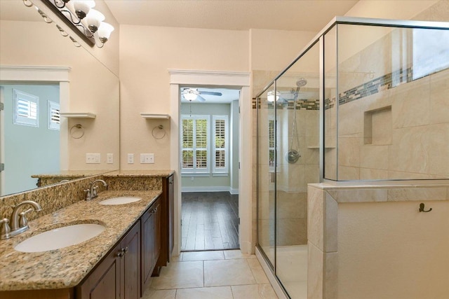 10908 Railway Ln Unit 76, Austin, TX 78717 - bathroom featuring a shower stall, double vanity, a ceiling fan, and tile patterned flooring