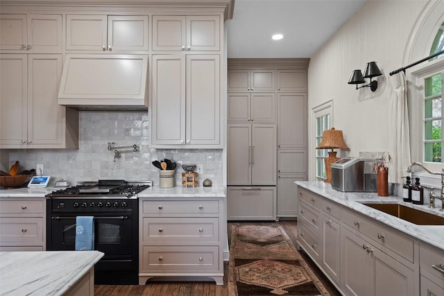 6203 Ledge Mountain Dr, Austin, TX 78731 - kitchen with black gas range oven, premium range hood, a sink, backsplash, and dark wood-style floors