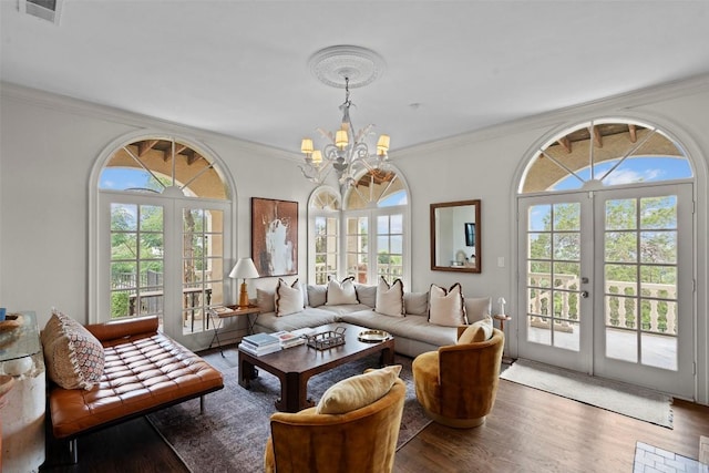6203 Ledge Mountain Dr, Austin, TX 78731 - living room featuring a chandelier, healthy amount of natural light, crown molding, and wood finished floors