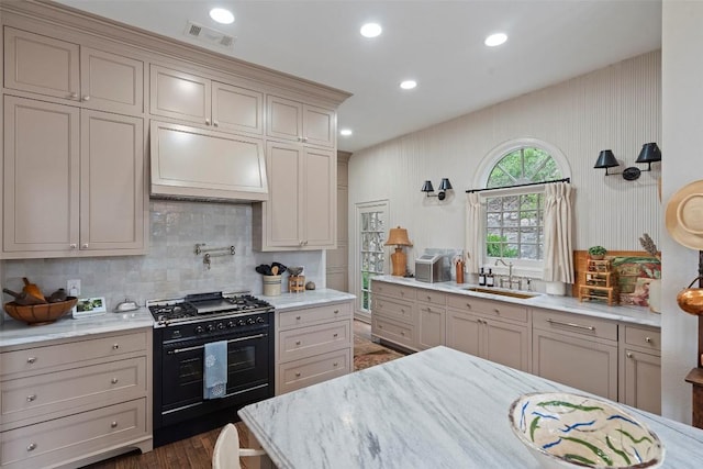 6203 Ledge Mountain Dr, Austin, TX 78731 - kitchen featuring a sink, black gas stove, tasteful backsplash, premium range hood, and recessed lighting