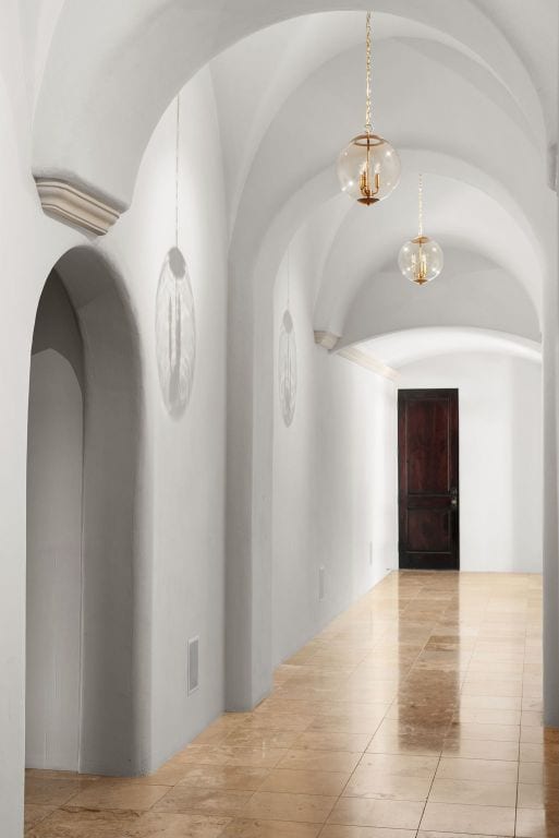 4256 Fischer Store Rd, Wimberley, TX 78676 - hallway with arched walkways, a chandelier, and tile patterned flooring