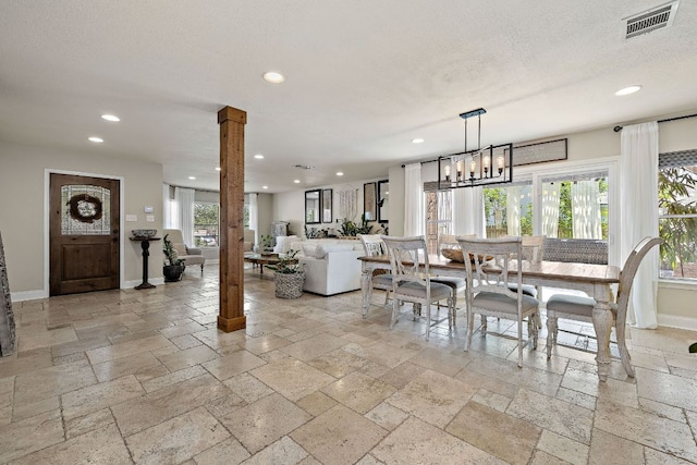 1705 Chinati Ct, Cedar Park, TX 78613 - dining room featuring stone tile flooring, recessed lighting, baseboards, ornate columns, and a chandelier
