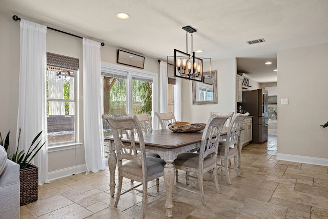 1705 Chinati Ct, Cedar Park, TX 78613 - dining room with stone tile flooring, a chandelier, baseboards, and recessed lighting