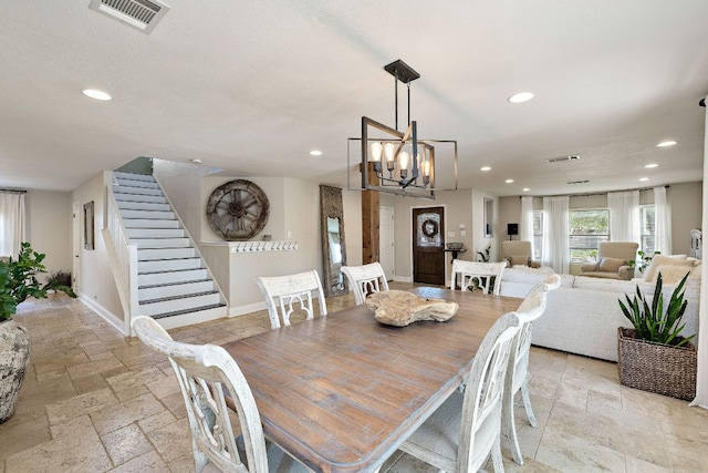1705 Chinati Ct, Cedar Park, TX 78613 - dining area featuring stone tile flooring, recessed lighting, stairs, a chandelier, and baseboards