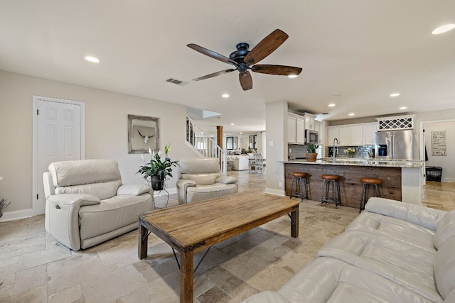 1705 Chinati Ct, Cedar Park, TX 78613 - living room with ceiling fan, recessed lighting, baseboards, stone tile flooring, and stairs