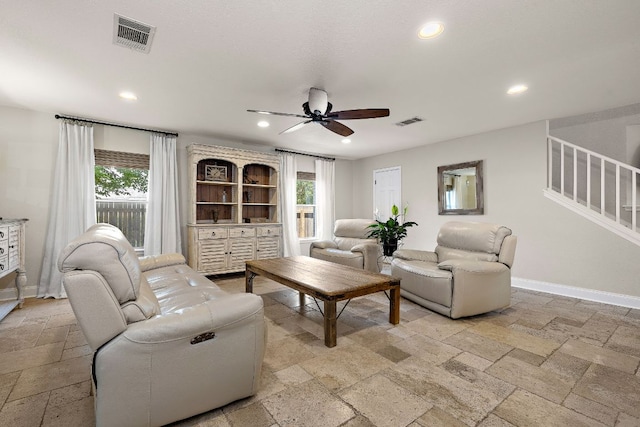 1705 Chinati Ct, Cedar Park, TX 78613 - living room featuring stone tile floors, ceiling fan, stairway, recessed lighting, and plenty of natural light