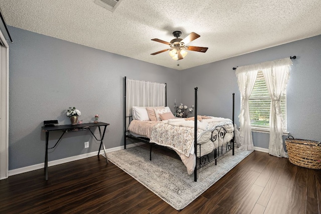 1705 Chinati Ct, Cedar Park, TX 78613 - bedroom with a textured ceiling, dark wood-style floors, baseboards, and a ceiling fan
