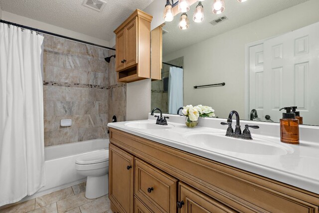 1705 Chinati Ct, Cedar Park, TX 78613 - bathroom with double vanity, shower / bath combo, toilet, a textured ceiling, and tile patterned floors