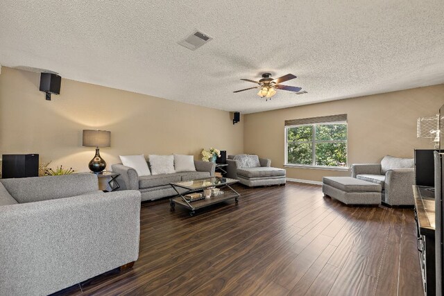 1705 Chinati Ct, Cedar Park, TX 78613 - living room featuring dark wood-style flooring, ceiling fan, a textured ceiling, and baseboards