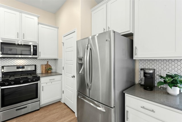 11805 Bracco Dr, Austin, TX 78748 - kitchen with stainless steel appliances, backsplash, white cabinetry, and dark countertops