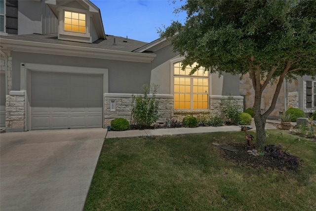 11805 Bracco Dr, Austin, TX 78748 - view of front of house with stone siding, concrete driveway, stucco siding, and a front yard