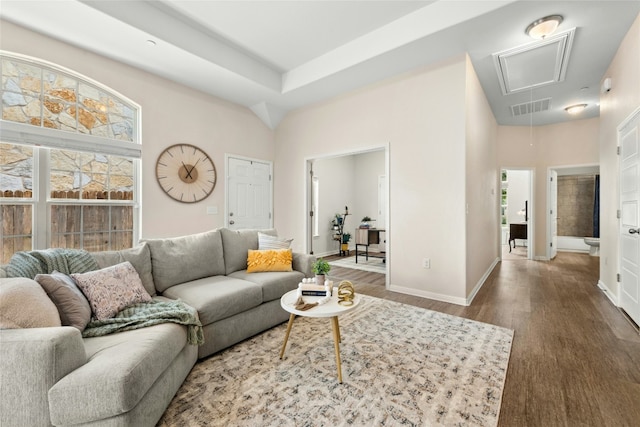 11805 Bracco Dr, Austin, TX 78748 - living area with attic access, wood finished floors, a towering ceiling, and baseboards