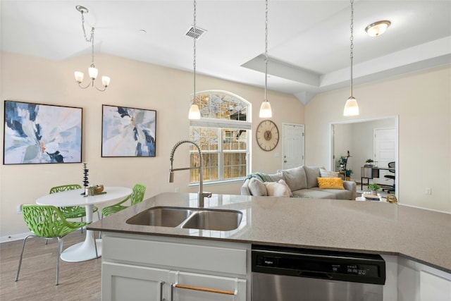 11805 Bracco Dr, Austin, TX 78748 - kitchen with a sink, stainless steel dishwasher, open floor plan, and white cabinets