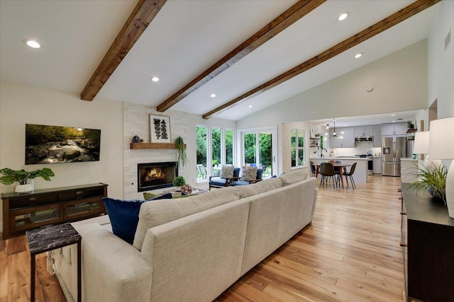 12801 Oak Bend Cv, Austin, TX 78727 - living area with a large fireplace, light wood-type flooring, recessed lighting, and a chandelier