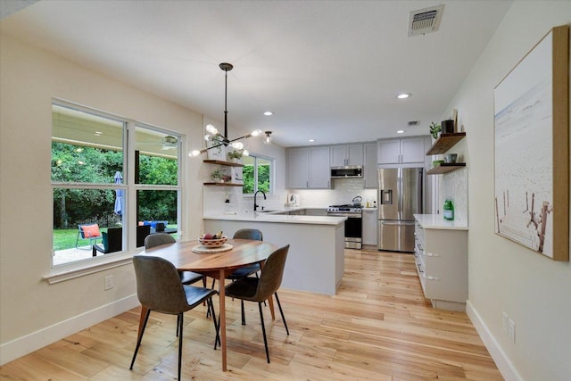 12801 Oak Bend Cv, Austin, TX 78727 - dining area featuring light wood-type flooring, recessed lighting, and a chandelier
