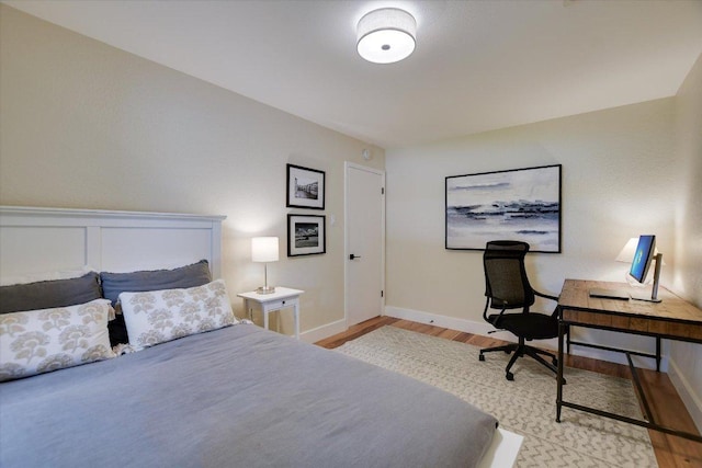12801 Oak Bend Cv, Austin, TX 78727 - bedroom featuring wood finished floors, baseboards, and a desk
