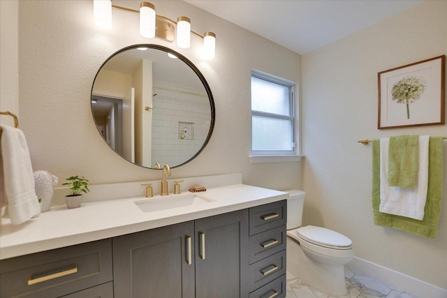 12801 Oak Bend Cv, Austin, TX 78727 - full bathroom with vanity, toilet, marble look tiles, and baseboards