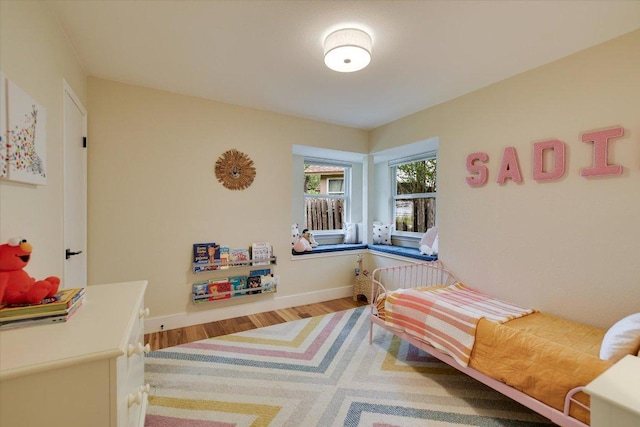 12801 Oak Bend Cv, Austin, TX 78727 - bedroom with wood finished floors and baseboards