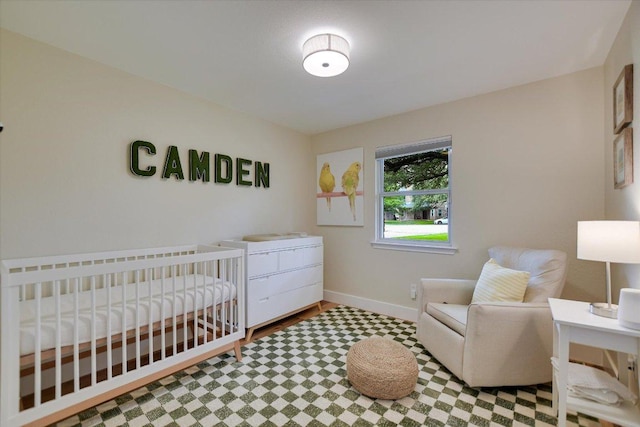 12801 Oak Bend Cv, Austin, TX 78727 - bedroom featuring baseboards, tile patterned floors, and a nursery area