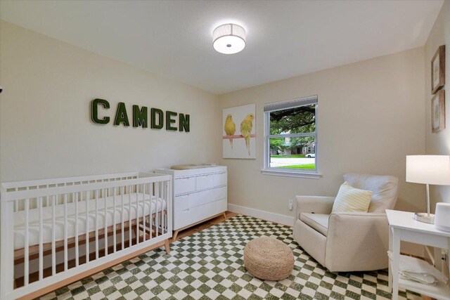 12801 Oak Bend Cv, Austin, TX 78727 - bedroom featuring tile patterned floors and a crib