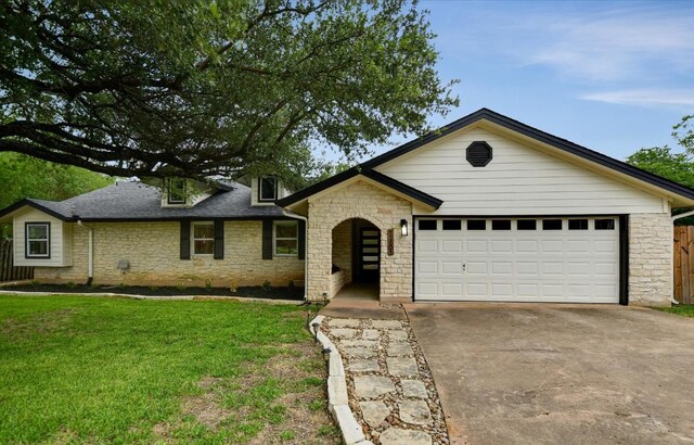 12801 Oak Bend Cv, Austin, TX 78727 - view of front of property with stone siding, driveway, and an attached garage