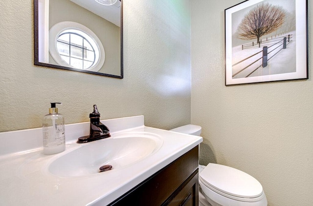14309 Richard Walker Blvd, Austin, TX 78728 - half bathroom with toilet, vanity, and a textured wall