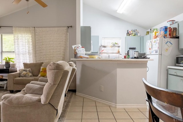 2903 W Slaughter Ln, Austin, TX 78748 - kitchen featuring freestanding refrigerator, a ceiling fan, stainless steel microwave, light tile patterned flooring, and open floor plan