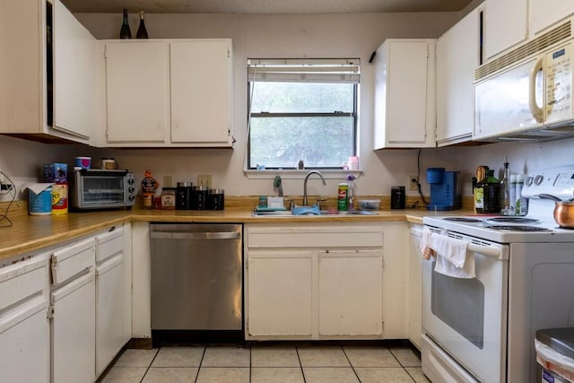 2903 W Slaughter Ln, Austin, TX 78748 - kitchen with white appliances, a sink, light tile patterned floors, and white cabinets