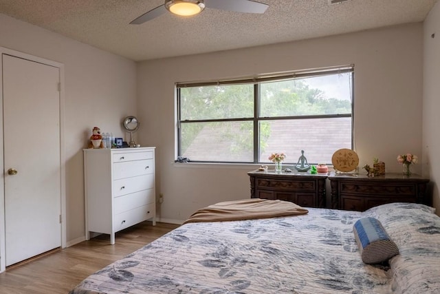 2903 W Slaughter Ln, Austin, TX 78748 - bedroom featuring wood finished floors, a textured ceiling, ceiling fan, and baseboards