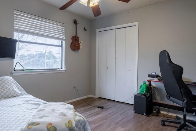 2903 W Slaughter Ln, Austin, TX 78748 - bedroom featuring wood finished floors, an office area, a closet, ceiling fan, and baseboards