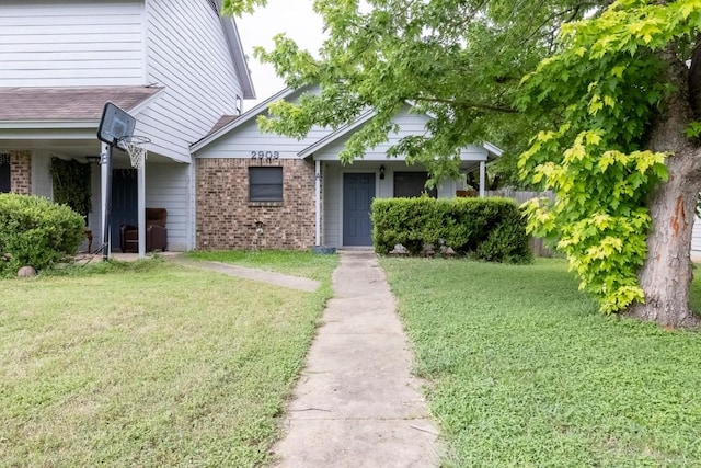 2903 W Slaughter Ln, Austin, TX 78748 - view of front of property featuring brick siding and a front lawn