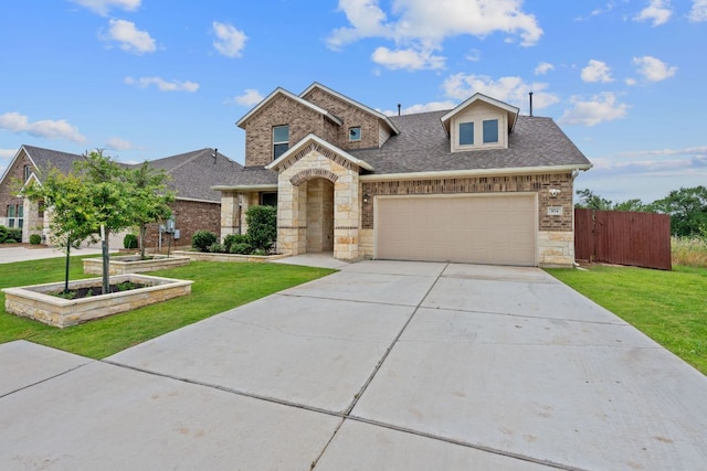 104 Meadow Wood Cv, Georgetown, TX 78626 - view of front of property featuring driveway, roof with shingles, an attached garage, stone siding, and brick siding