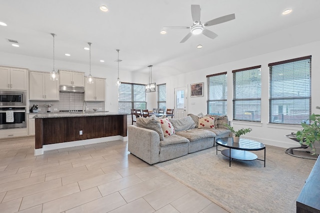 104 Meadow Wood Cv, Georgetown, TX 78626 - living area with recessed lighting, ceiling fan, and baseboards