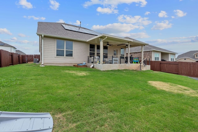 104 Meadow Wood Cv, Georgetown, TX 78626 - back of property featuring a ceiling fan, solar panels, a patio area, central AC, and a shingled roof