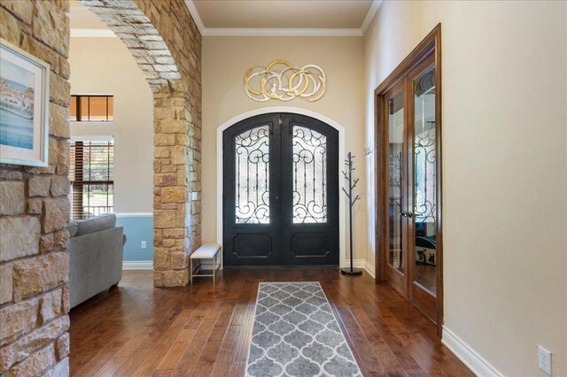 102 Standing Oak Dr, Georgetown, TX 78633 - entryway with french doors, arched walkways, wood finished floors, and ornamental molding