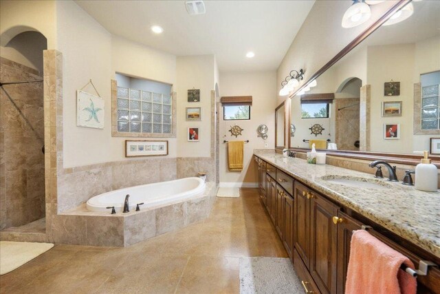 102 Standing Oak Dr, Georgetown, TX 78633 - bathroom featuring a bath, a walk in shower, double vanity, tile patterned floors, and recessed lighting