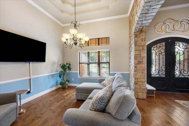 102 Standing Oak Dr, Georgetown, TX 78633 - living area featuring a chandelier, wood finished floors, ornamental molding, a tray ceiling, and french doors