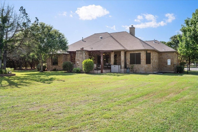 102 Standing Oak Dr, Georgetown, TX 78633 - rear view of house featuring a chimney, a lawn, and a patio
