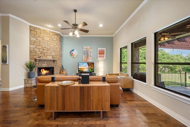 102 Standing Oak Dr, Georgetown, TX 78633 - living area featuring a ceiling fan, dark wood-type flooring, a stone fireplace, ornamental molding, and recessed lighting