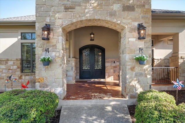 102 Standing Oak Dr, Georgetown, TX 78633 - entrance to property with french doors, roof with shingles, and stone siding