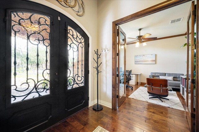 102 Standing Oak Dr, Georgetown, TX 78633 - entryway featuring french doors, wood finished floors, arched walkways, and a ceiling fan