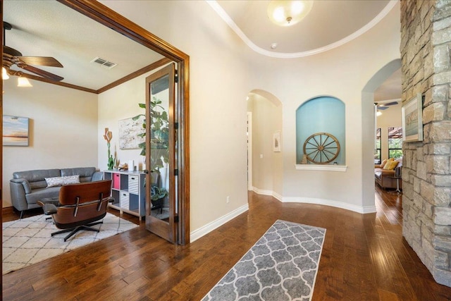 102 Standing Oak Dr, Georgetown, TX 78633 - foyer entrance featuring ceiling fan, arched walkways, hardwood / wood-style flooring, ornamental molding, and a high ceiling