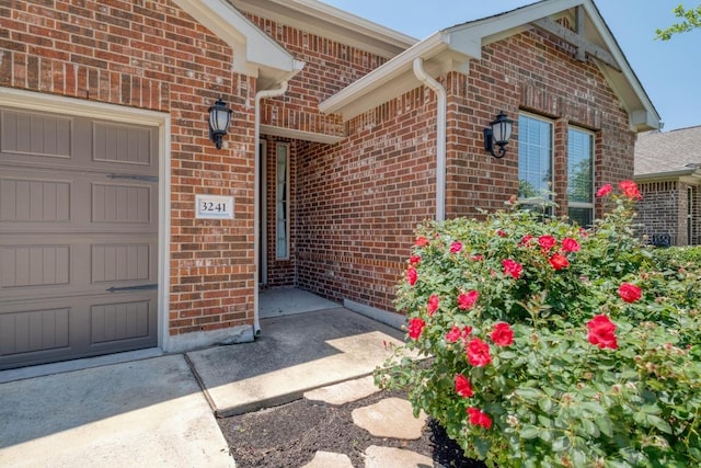 3241 Aurelia Ln, Round Rock, TX 78665 - view of exterior entry with brick siding and an attached garage