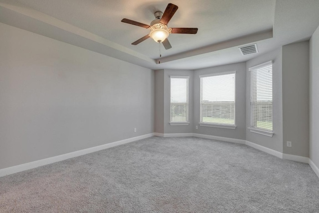 3241 Aurelia Ln, Round Rock, TX 78665 - unfurnished room with light colored carpet, baseboards, ceiling fan, and a tray ceiling