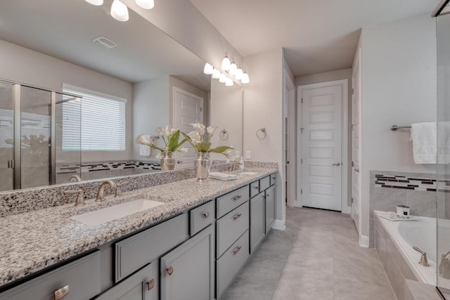 3241 Aurelia Ln, Round Rock, TX 78665 - bathroom featuring double vanity, a bath, a shower stall, and tile patterned flooring