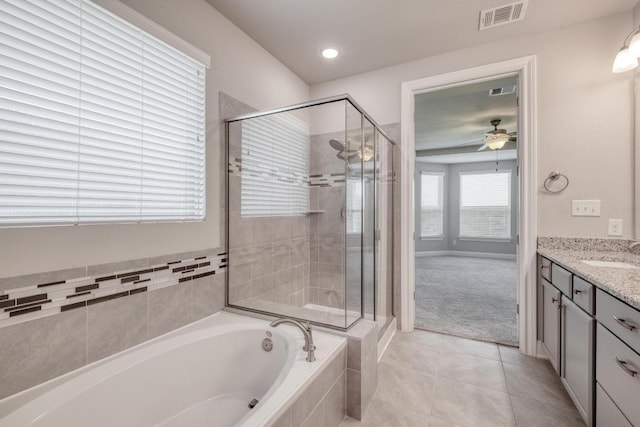 3241 Aurelia Ln, Round Rock, TX 78665 - full bathroom featuring a bath, vanity, a stall shower, tile patterned floors, and a ceiling fan