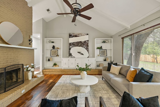 13007 Stillforest St, Austin, TX 78729 - living area with ceiling fan, high vaulted ceiling, dark wood-style floors, built in shelves, and a brick fireplace